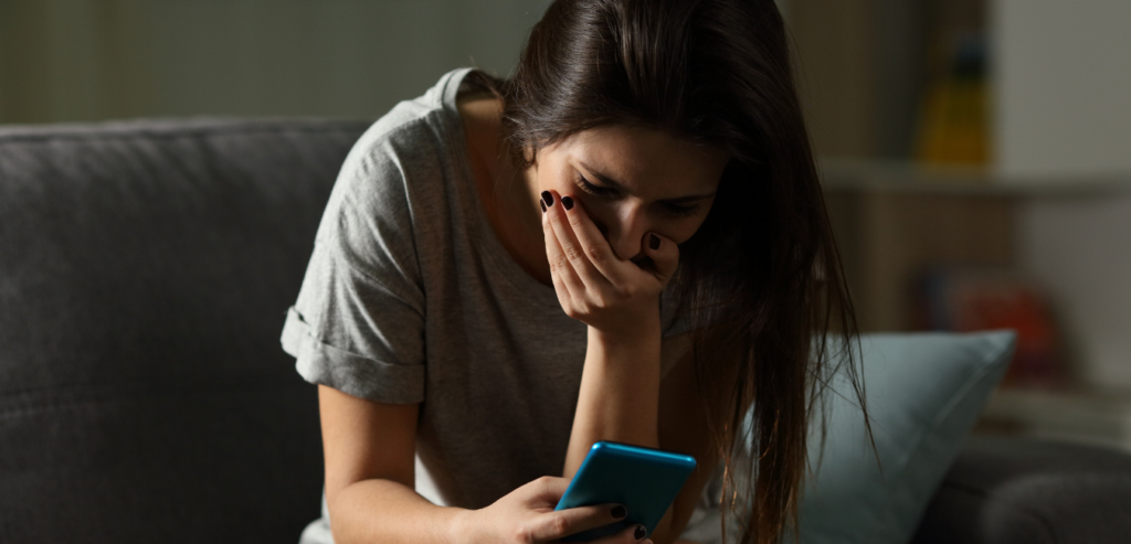 woman shocked looking at phone